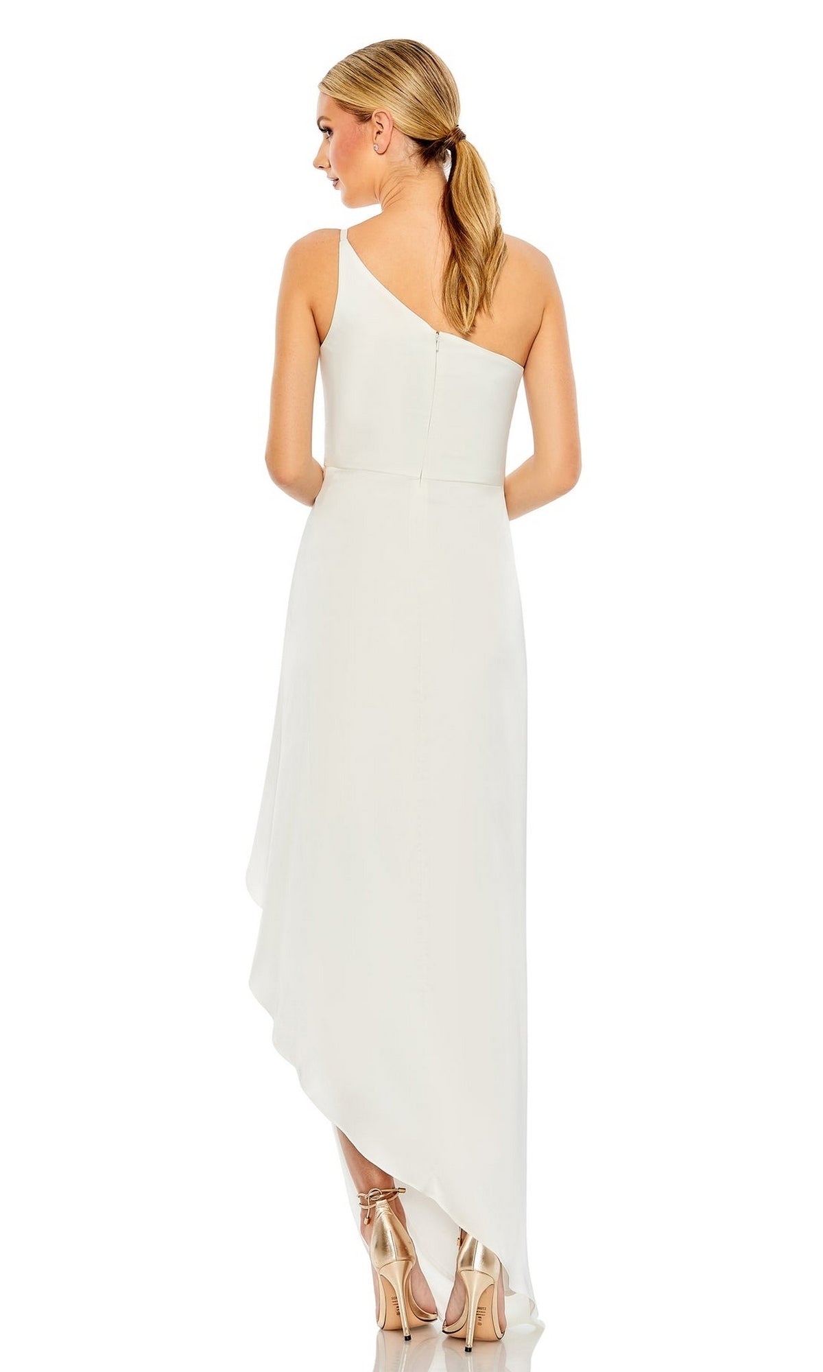 A woman with blonde hair in a ponytail, seen from behind, wears the Mac Duggal 70177 High-Low Wedding Guest Dress in white with metallic high-heeled sandals.